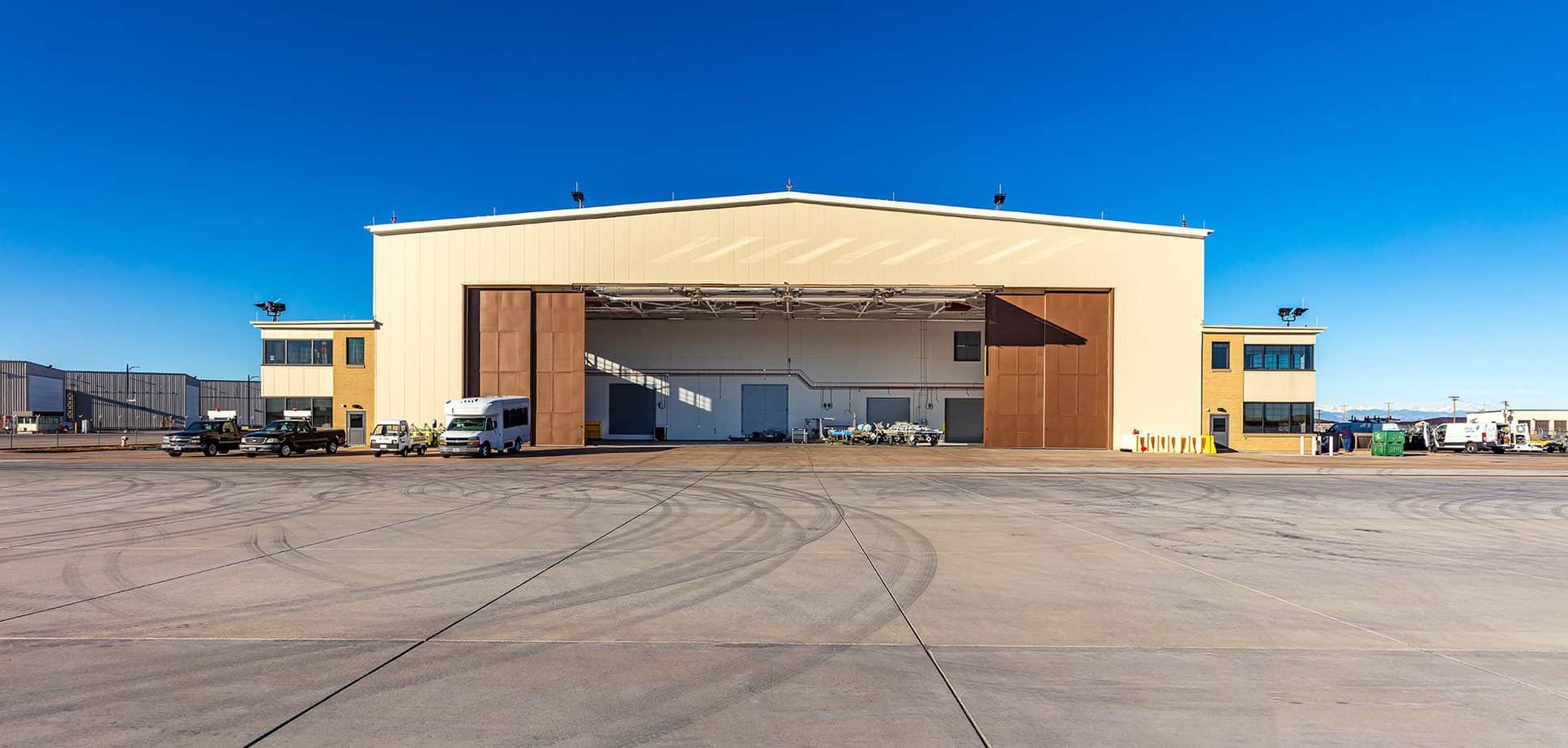 Exterior view of the Buckley Air Force Base, Hangar 909 against a blue sky.