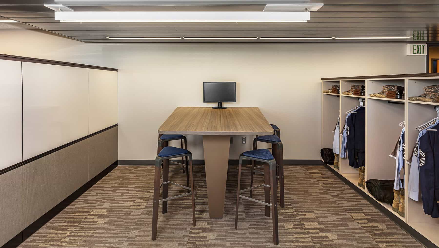 High top table with high chairs in the common room with personal storage space