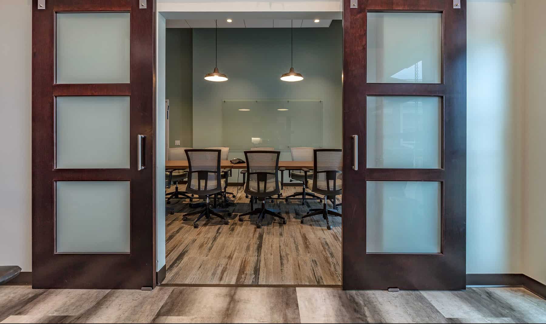 Sliding doors revealing the interior conference room of The Town of Bennett Town Hall