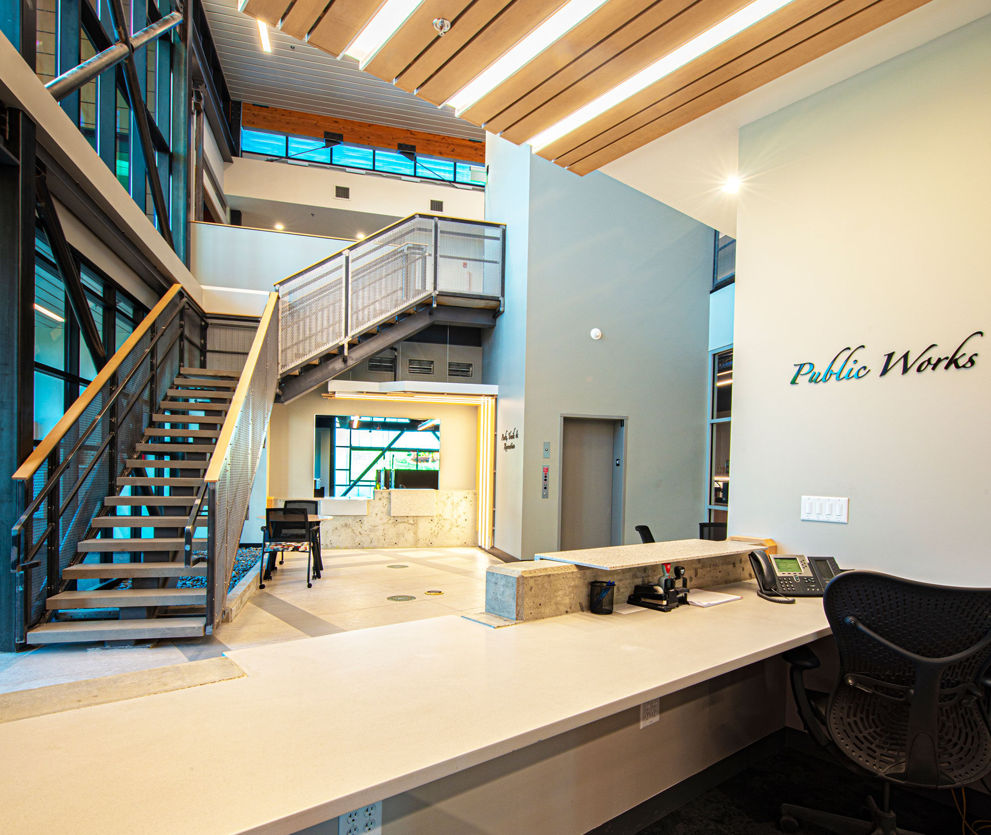 The perspective of behind the reception desk for the Public Works office looking into the lobby