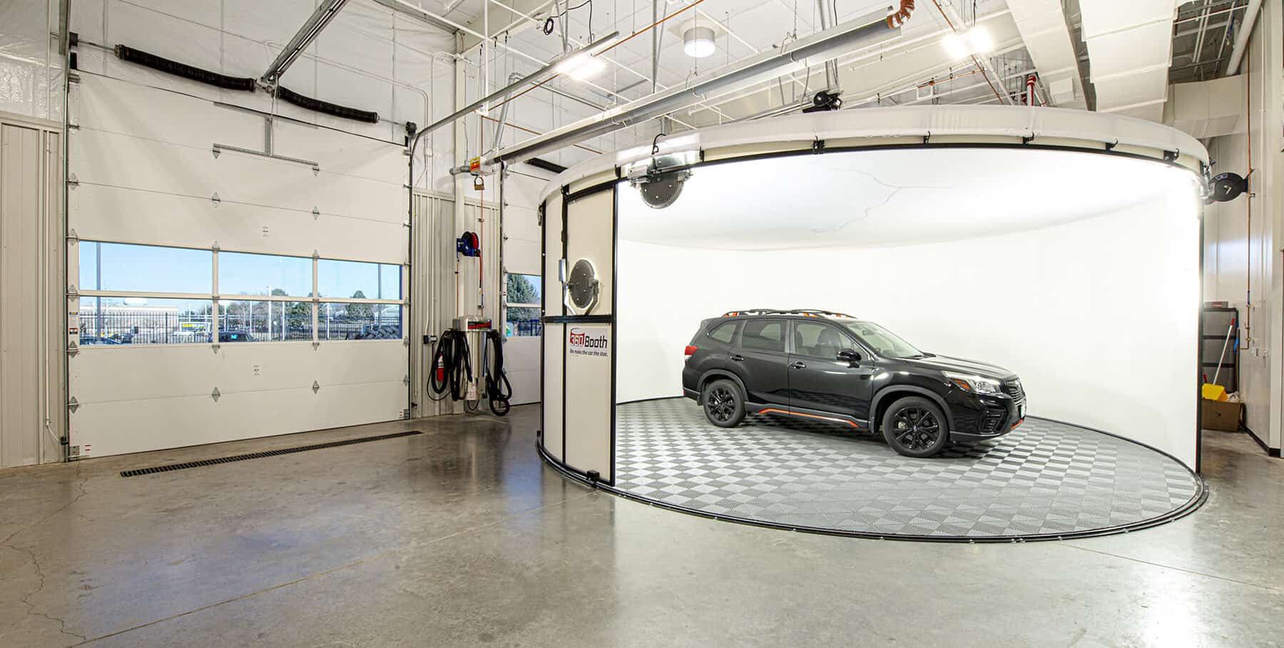 Showroom-quality car by the bay doors on the Mike Shaw Service Center