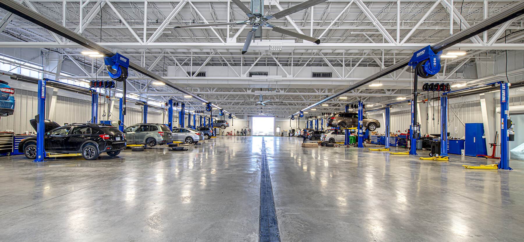 The work bay filled with cars being serviced at the Mike Shaw Service Center designed by D2C Architects.